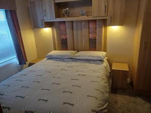 a bedroom with a bed with fish on it at The Highlander in Tain