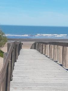 a wooden boardwalk leading to the beach at LAS TONINAS - CASAS DE PLAYA - a 50 metros del mar in Monte Hermoso