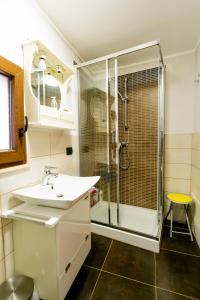 a bathroom with a sink and a shower at Domus Teja in Agira