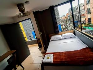 Voodi või voodid majutusasutuse Hotel Ruiseñor Itagui toas