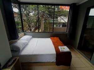 Voodi või voodid majutusasutuse Hotel Ruiseñor Itagui toas