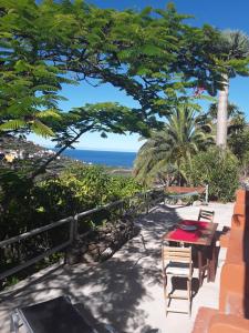a patio with a table and a view of the ocean at Casa Panama in Hermigua