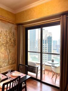a dining room with a table and a balcony with a view at Sunkissed holiday homes Stunning marina view 4BR plus maid room on JBR beach near mall in Dubai
