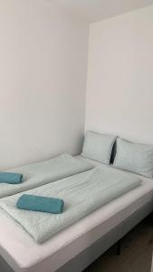 een bed met twee kussens erop bij Éva Apartmanház 3 in Csopak