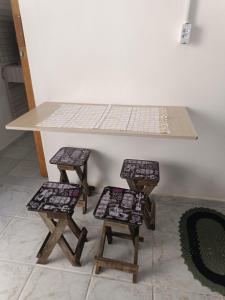 ガラパリにあるTemporada Praia de Setibaの三脚の椅子が置かれたテーブル