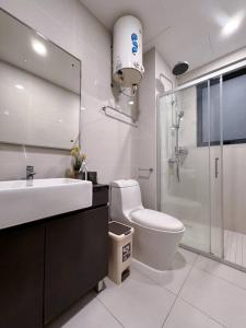 a bathroom with a toilet and a sink and a shower at Wind Serenity & FOC Netflix Access Country Garden Danga Bay 3BR # 6-11 pax by Minshuku in Johor Bahru