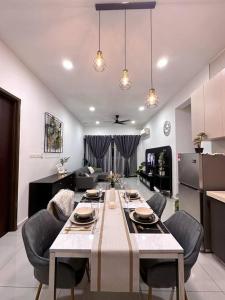 a living room with a table and a kitchen at Wind Serenity & FOC Netflix Access Country Garden Danga Bay 3BR # 6-11 pax by Minshuku in Johor Bahru