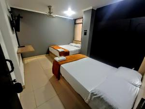 Voodi või voodid majutusasutuse Hotel Ruiseñor Itagui toas