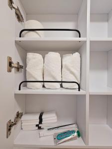 a closet with white towels and a rack with towels at Moonlight Sonata in Bucheon