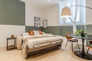 a bedroom with a bed and a table at Discover Apartment in Livorno