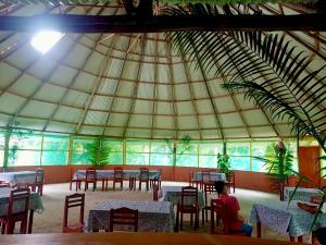 a room with tables and chairs in a tent at Amazon Nativo Lodge in San Pedro