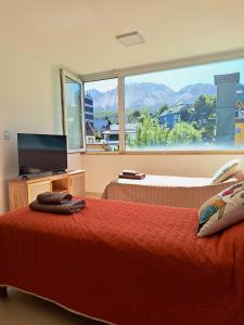 a bedroom with two beds and a large window at Lo de Gaston in Ushuaia