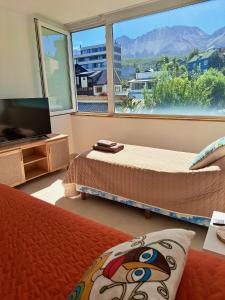 a bedroom with two beds and a large window at Lo de Gaston in Ushuaia