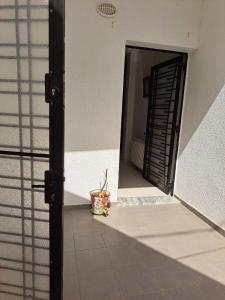 a door to a building with a potted plant in the doorway at Dar Saloua in Nabeul +1 photo
