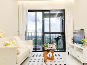 a living room with a couch and a large window at Bukit Indah 1/Studio/Aeon Mall in Johor Bahru