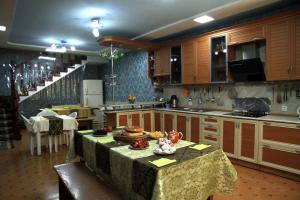 a kitchen with a table in the middle of it at Yellow Hostel Dushanbe in Dushanbe