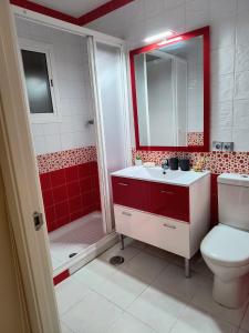 a bathroom with a toilet and a sink and a shower at Casa El limonero in Seville +14 photos
