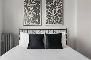 una camera da letto con 2 immagini incorniciate sopra un letto di 1BR Stylish & Modern Chicago Apartment - Kenwood 508 a Chicago