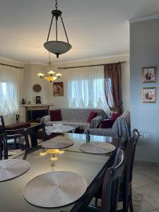 a dining room and living room with a table and chairs at Athina's House in Xanthi