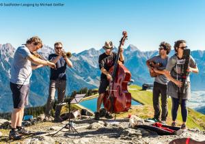 a group of people playing music on a mountain at Appartements Kuckuck Leogang in Leogang