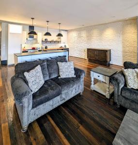 a living room with a couch and a table at Cherry Street Luxury Apartment in Helena