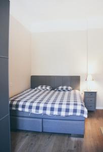 a bedroom with a blue bed with two pillows at Luxury Renovated - 600 Mbit - 64 M2 - 65 inch TV in Rīga