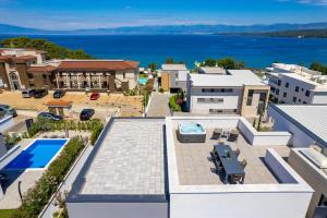 an aerial view of a house with a swimming pool at HADRIE LUXURY RESORT AND VILLAS PENTHOUSE de in Malinska