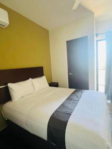Giường trong phòng chung tại REGMAR Progreso Yucatán