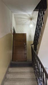 a staircase with a wooden door in a building at Chittagong Hotel & Apartment Service in Dhaka