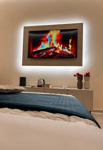 a bedroom with a bed with a tv on the wall at Mael Superior Room in Palermo +7 photos