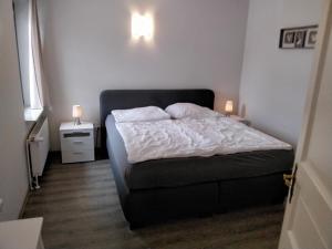 ein Schlafzimmer mit einem Bett und zwei Lampen an der Wand in der Unterkunft Ferienwohnung Neptun am Brunnenplatz Zentrum in Büsum