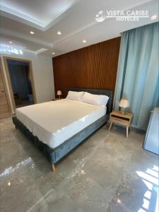 Säng eller sängar i ett rum på Hotel Vista Caribe Azúa