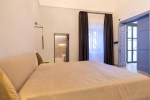 Letto o letti in una camera di Lucrezia Dimore - Ugento