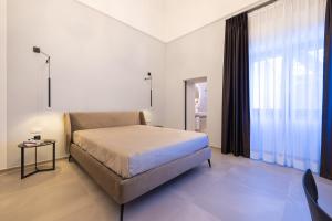 Letto o letti in una camera di Lucrezia Dimore - Ugento