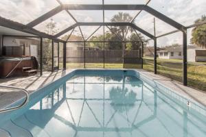 a swimming pool with a pergola and a swimming poolvisor at 10 Mins to Beach - 2BR Private Pool + Spa + Grill in Vero Beach