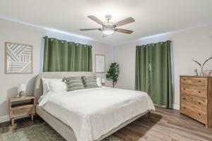 a bedroom with a bed and a ceiling fan at 10 Mins to Beach - 2BR Private Pool + Spa + Grill in Vero Beach