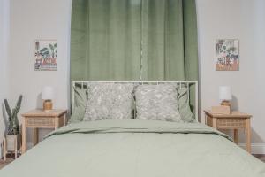 a bedroom with a bed with a green curtain at 10 Mins to Beach - 2BR Private Pool + Spa + Grill in Vero Beach