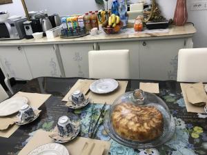 a table with a heart shaped cake on top of it at B&B 3 Stelle - La perla bianca in Càbras
