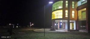 a large building at night with a light on it at Panorama Kyenjojo Hotel in Kyenjojo