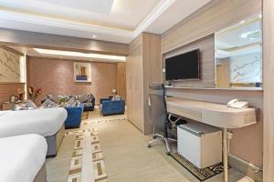 Pokój hotelowy z łóżkiem i biurkiem w obiekcie Trans World Hotel w Dubaju