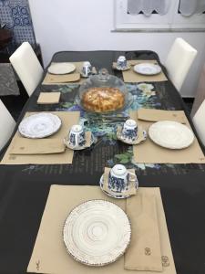 a black table with plates and dishes on it at B&B 3 Stelle - La perla bianca in Càbras