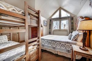 a bedroom with two bunk beds and a window at Unbelievable Location on Main Street - Walk Everywhere, Private Hot Tub! DOG FRIENDLY SCC4 in Breckenridge