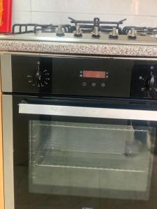 a stove top oven with its door open in a kitchen at MAYRAH Inn - Your comfortable home from home in Freetown Sierra Leone in Goderich