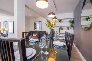 a dining room with a black table and chairs at The Hamptons by Brighton Holiday Lets in Brighton & Hove +31 photos
