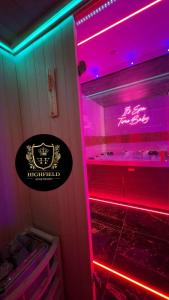 a refrigerator with purple and pink lights in a room at HIGHFIELD PRIVATE SPA APARTMENT in Bradford