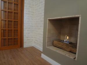 a room with a fireplace with a candle in it at Hotel Pousada Água Da Mina in Monte Sião +70 photos