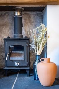 a stove and a vase with flowers in a room at The Tartan Terrace in Inverness