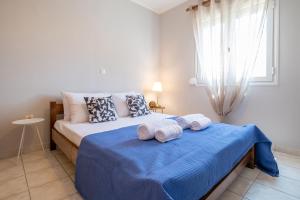 a bedroom with a bed with towels on it at Park View in Myrina
