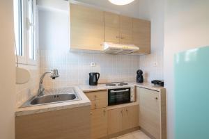 a small kitchen with a sink and a microwave at Park View in Myrina +9 photos