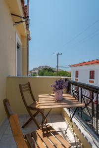 a wooden table and chairs sitting on a balcony at Park View in Myrina